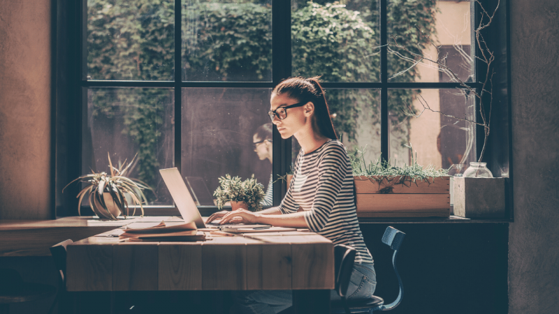 Woman writing at laptop